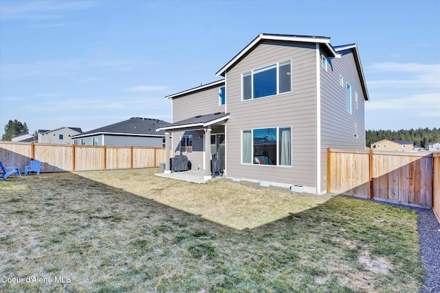 back of house with a patio, a lawn, a fenced backyard, and crawl space