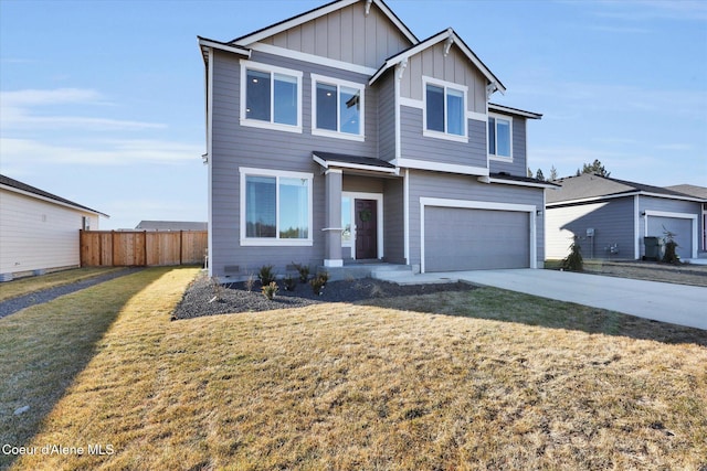 view of front facade featuring a front yard, fence, driveway, an attached garage, and board and batten siding