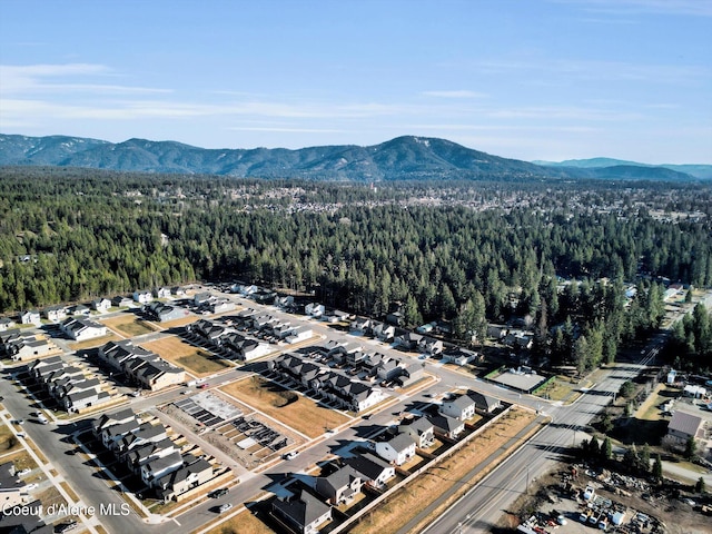 birds eye view of property with a mountain view and a view of trees