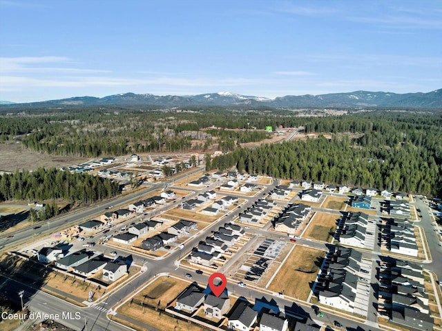 drone / aerial view with a mountain view and a forest view