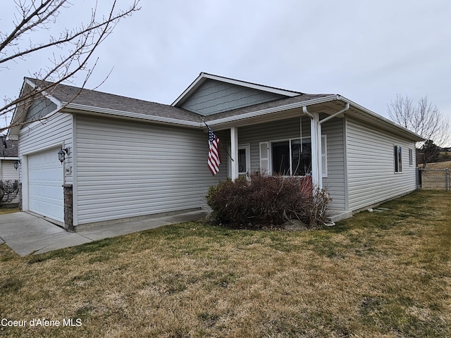 view of front of house with an attached garage, a front yard, and fence