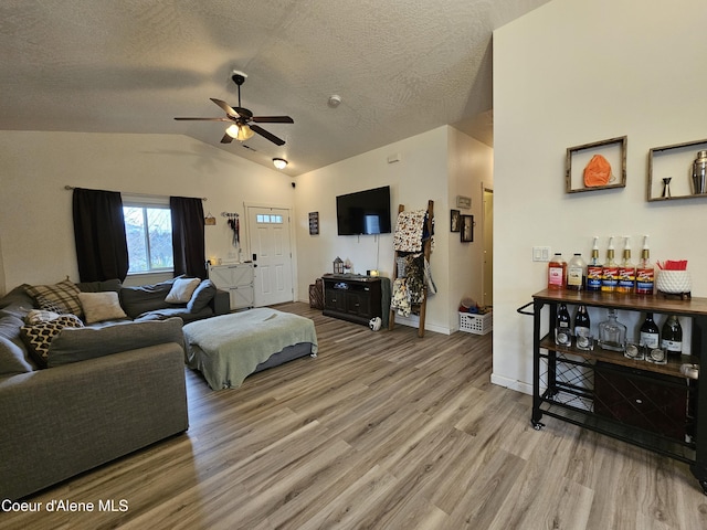 4346 N Brookie Dr, Post Falls, ID 83854 - living room with a textured ceiling, wood finished floors, vaulted ceiling, and a ceiling fan