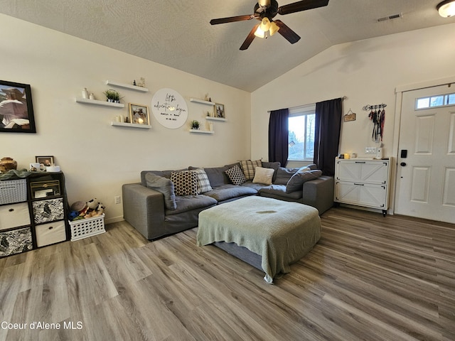 4346 N Brookie Dr, Post Falls, ID 83854 - living room with visible vents, vaulted ceiling, ceiling fan, and wood finished floors