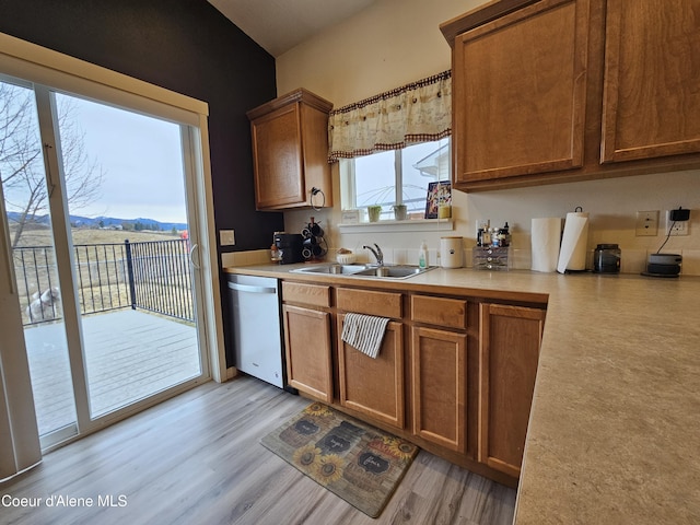 4346 N Brookie Dr, Post Falls, ID 83854 - kitchen featuring a sink, light countertops, brown cabinets, and dishwasher