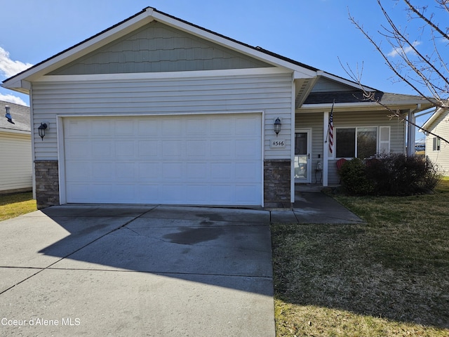 4346 N Brookie Dr, Post Falls, ID 83854 - view of front facade with stone siding, a front lawn, and an attached garage
