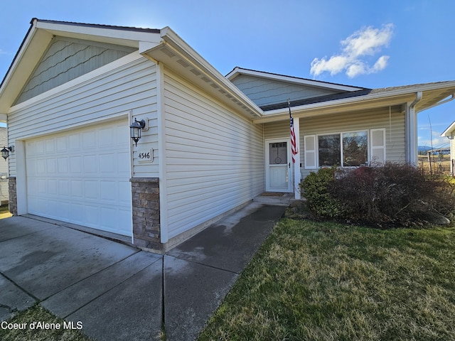 4346 N Brookie Dr, Post Falls, ID 83854 - ranch-style house featuring driveway, stone siding, and a garage