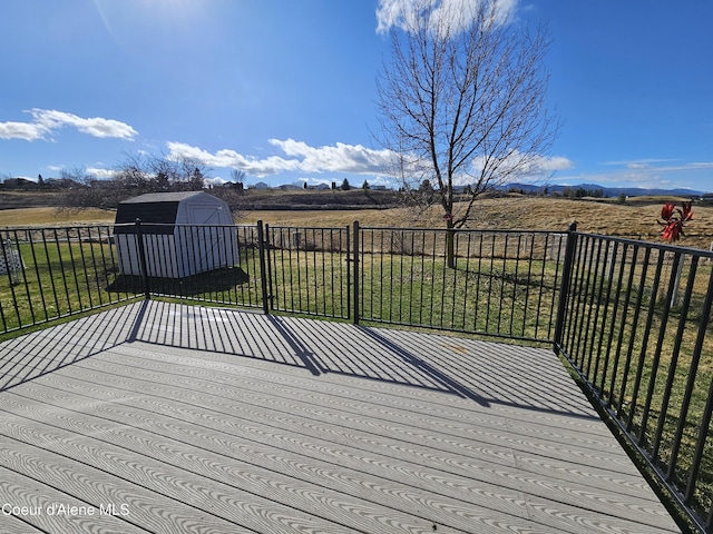 4346 N Brookie Dr, Post Falls, ID 83854 - deck featuring a lawn, an outbuilding, a shed, and a rural view