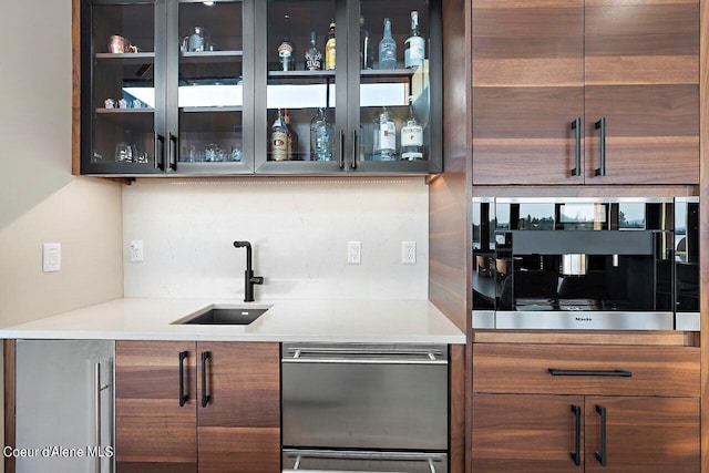 bar with indoor wet bar, decorative backsplash, appliances with stainless steel finishes, and a sink