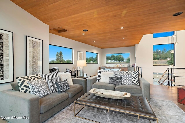 living area with recessed lighting and wooden ceiling