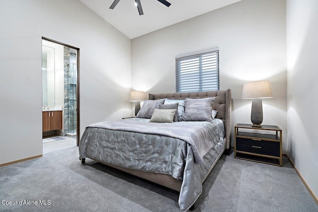 bedroom featuring a ceiling fan, baseboards, vaulted ceiling, light carpet, and connected bathroom