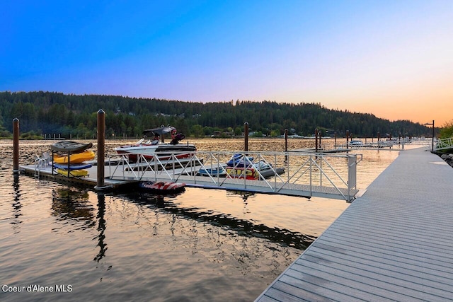 dock area with a view of trees and a water view