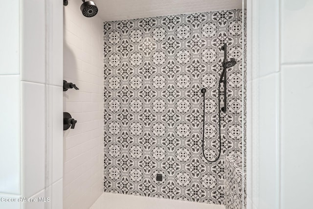 bathroom with a tile shower