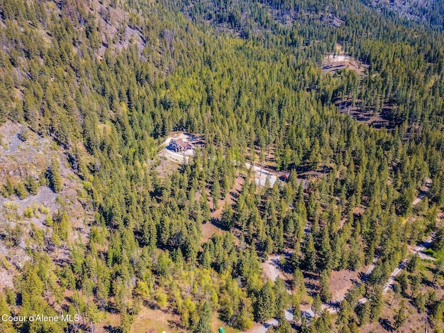 birds eye view of property featuring a view of trees