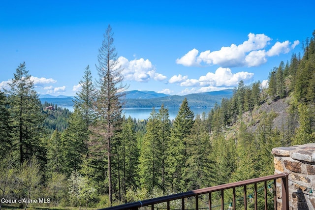 mountain view featuring a view of trees and a water view