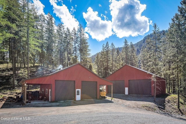 detached garage with a forest view