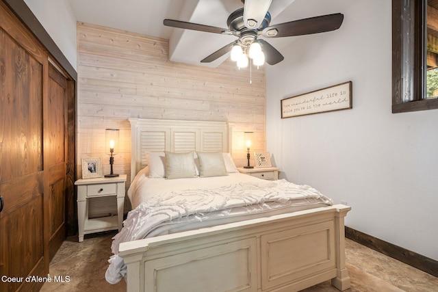 bedroom with baseboards, wooden walls, and ceiling fan