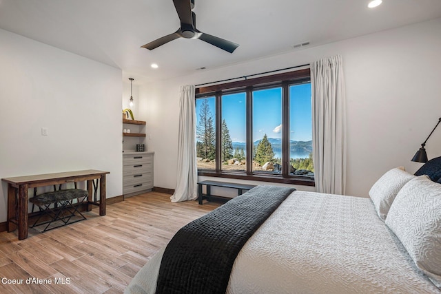 bedroom featuring visible vents, a ceiling fan, recessed lighting, light wood-style floors, and baseboards