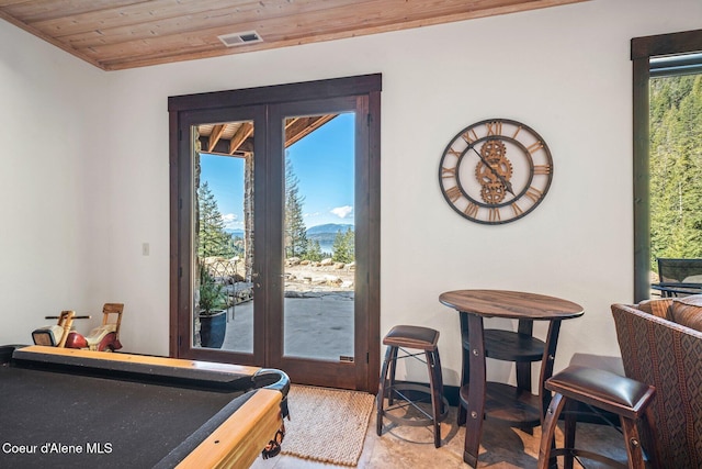 interior space with access to exterior, french doors, and wood ceiling