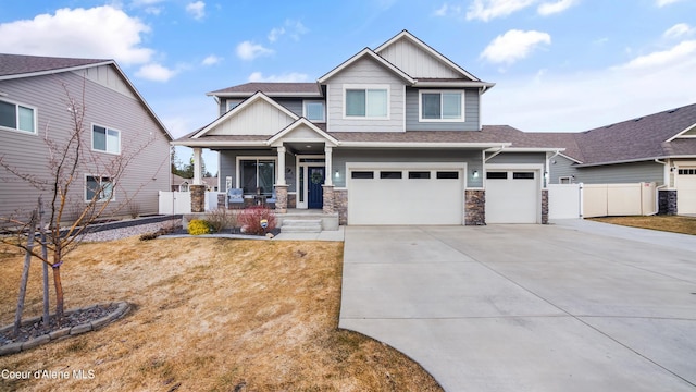 craftsman house featuring stone siding, a porch, fence, concrete driveway, and a garage