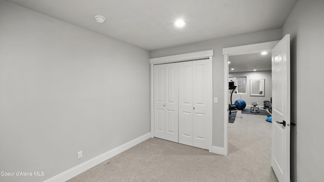 bedroom featuring a closet, carpet flooring, recessed lighting, and baseboards