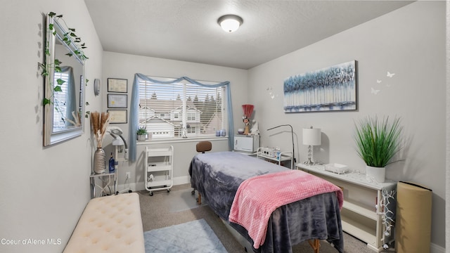 bedroom featuring carpet flooring, baseboards, and a textured ceiling