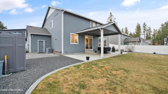 rear view of property featuring a patio, cooling unit, fence, entry steps, and a lawn