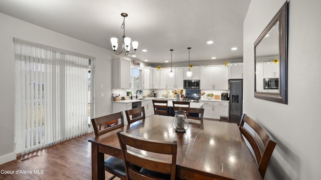 dining room featuring recessed lighting, visible vents, a notable chandelier, and wood finished floors