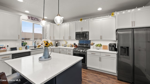 kitchen featuring a sink, stainless steel appliances, white cabinetry, and light countertops