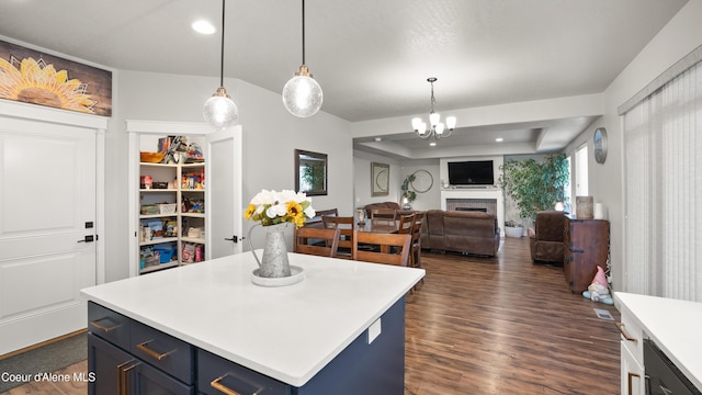 kitchen with dark wood-type flooring, blue cabinetry, open floor plan, a fireplace, and light countertops