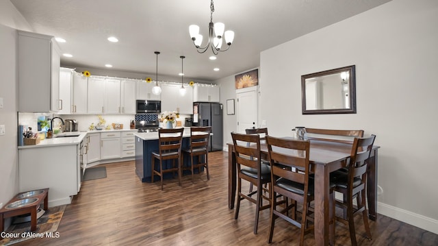 dining room featuring recessed lighting, dark wood-style floors, baseboards, and a chandelier