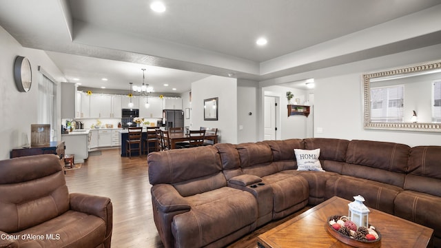 living area featuring recessed lighting, an inviting chandelier, and wood finished floors