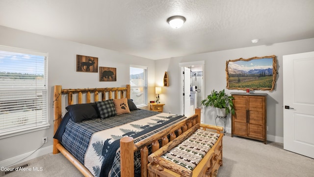 bedroom with a textured ceiling, baseboards, and light carpet