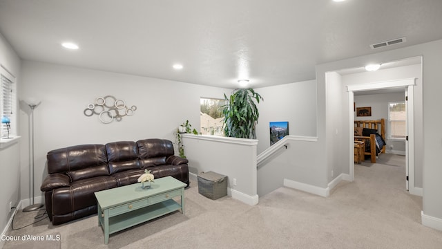 carpeted living room with visible vents, recessed lighting, and baseboards