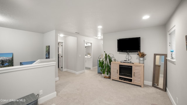 living room featuring visible vents, baseboards, and light colored carpet