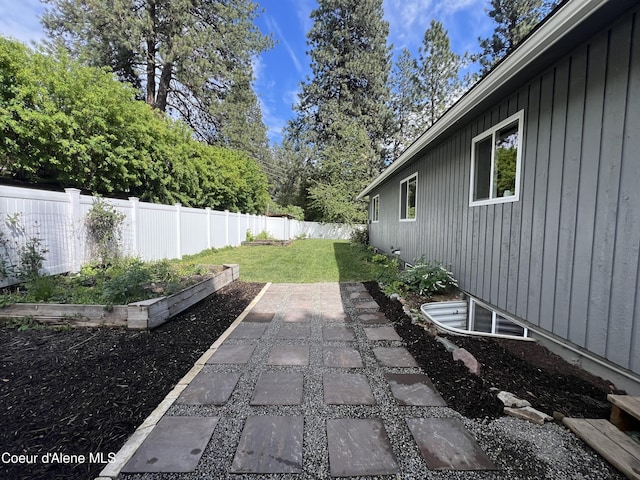 view of yard with a garden and a fenced backyard