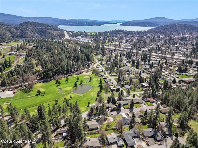 birds eye view of property featuring golf course view and a water and mountain view