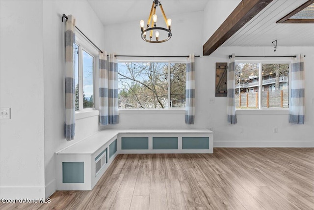 mudroom with baseboards, lofted ceiling with beams, an inviting chandelier, and wood finished floors