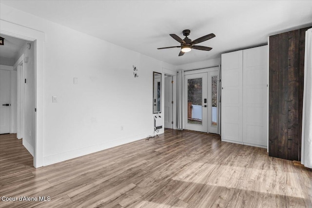 unfurnished bedroom with access to outside, ceiling fan, baseboards, and wood finished floors