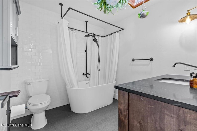 full bath with tile patterned floors, toilet, vanity, and shower / bath combo with shower curtain