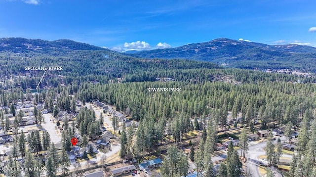 aerial view with a wooded view and a mountain view