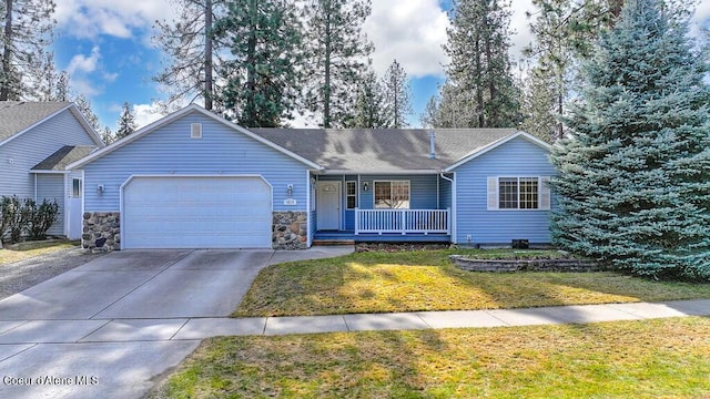 single story home featuring a garage, covered porch, concrete driveway, and a front yard