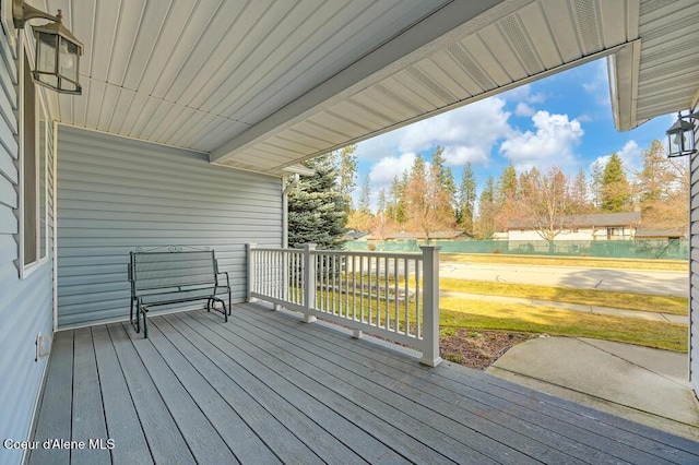 wooden deck with a lawn