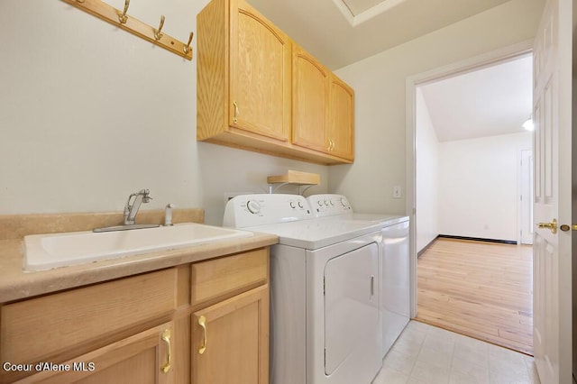 laundry area with a sink, cabinet space, and washer and clothes dryer