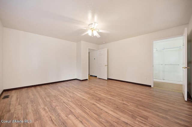 unfurnished room with light wood-style flooring, baseboards, visible vents, and ceiling fan