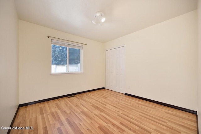 unfurnished room with visible vents, baseboards, and light wood finished floors