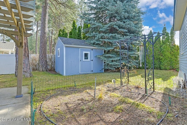 view of yard with a storage unit, an outdoor structure, and fence