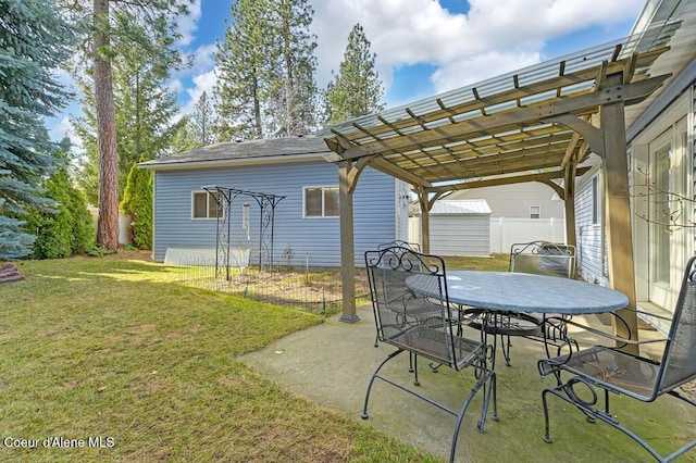 view of patio with outdoor dining area, an outbuilding, and a pergola