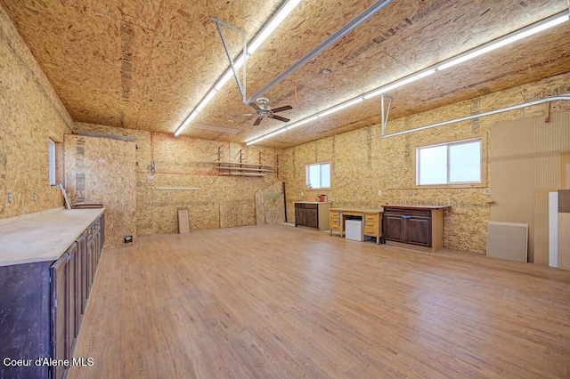 below grade area with wood finished floors and ceiling fan