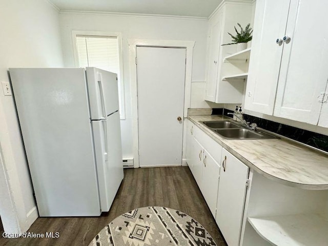 kitchen featuring a sink, white cabinetry, freestanding refrigerator, and open shelves