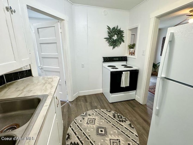 kitchen featuring crown molding, dark wood-type flooring, white cabinets, white appliances, and a sink